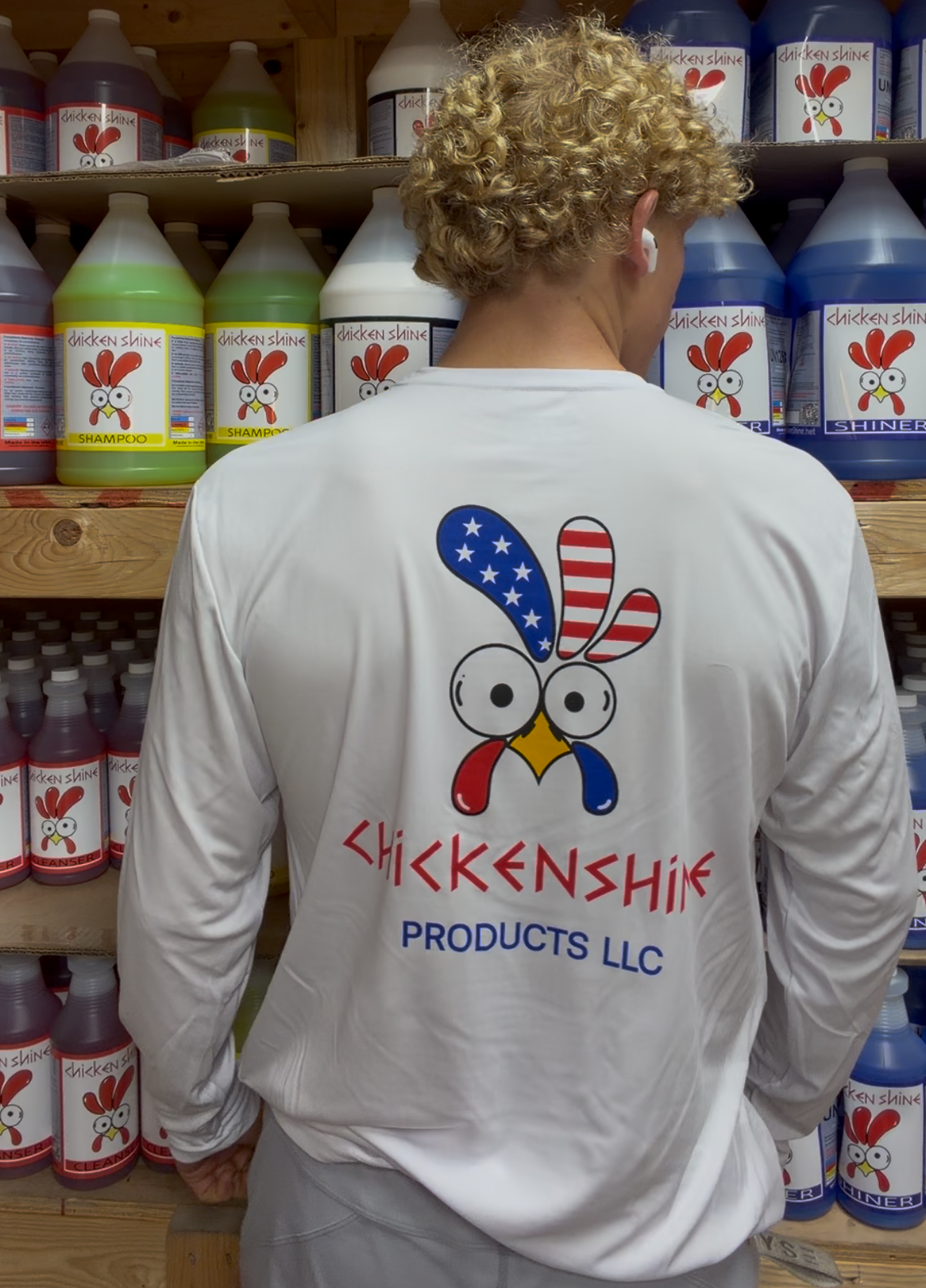 Person wearing a shirt with 'Chickenish Products LLC' logo in a store setting